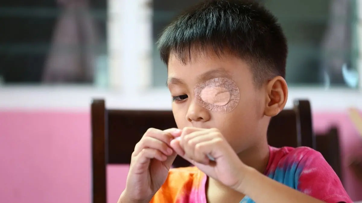 Child wearing eye patch playing game