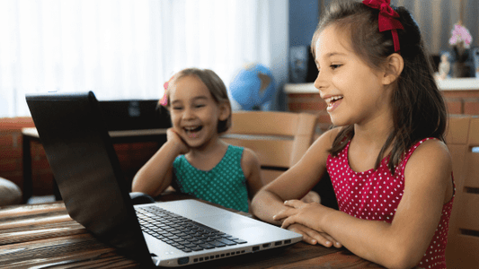 Children using a laptop screen at home