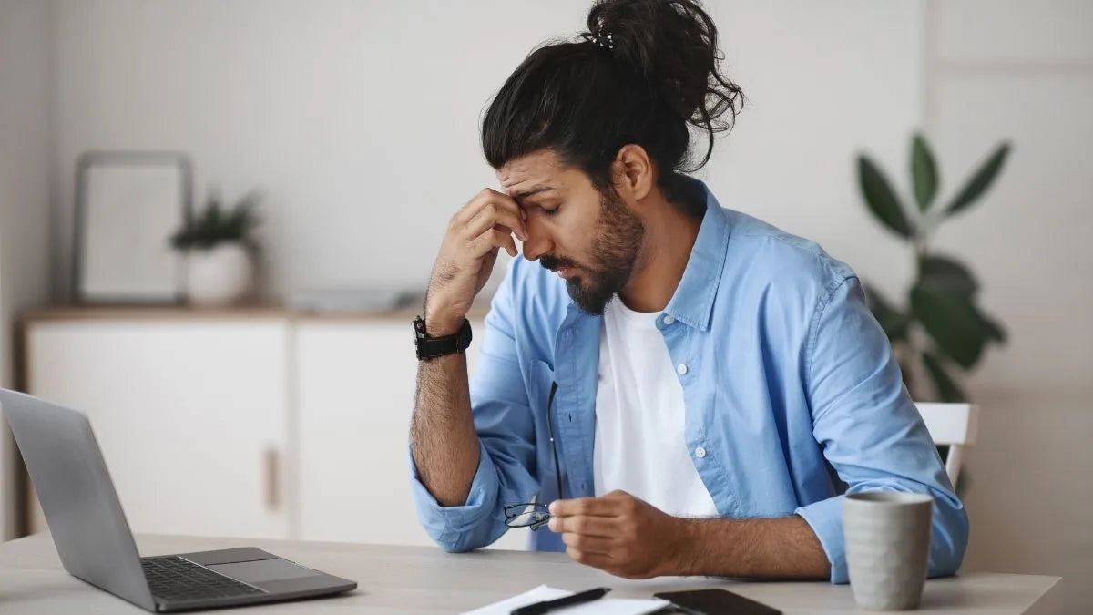 Person with tired eyes at laptop screen