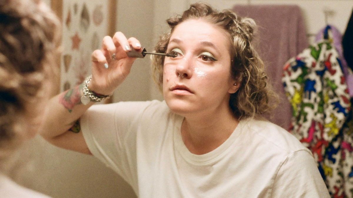 30yr_old_applying_old_makeup_at_a_party._blepharitis. evening. getting ready to go out. 