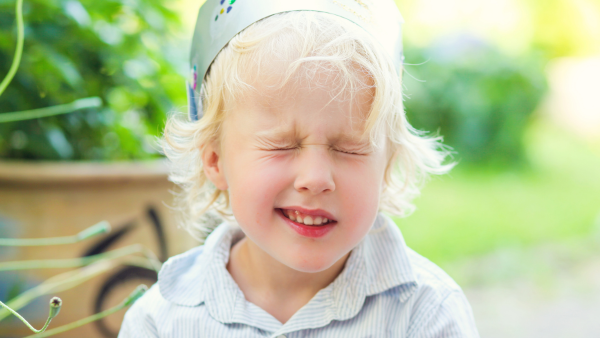 Child blinking outdoors in natural light
