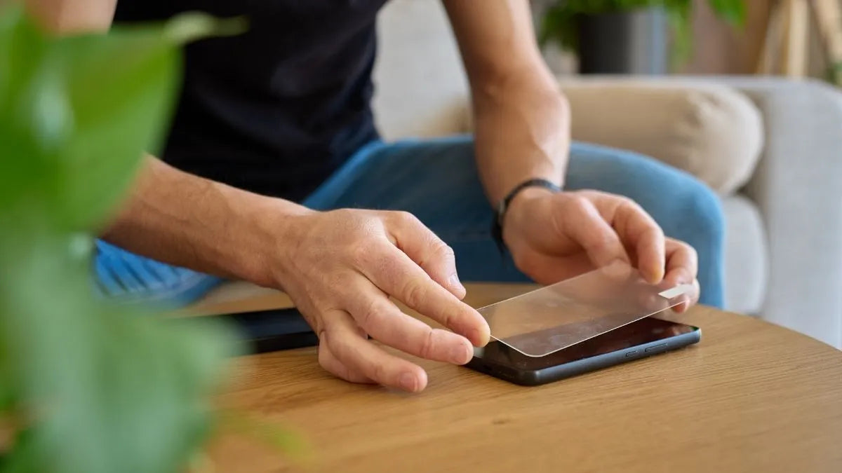 Screen protector being applied to a phone step by step